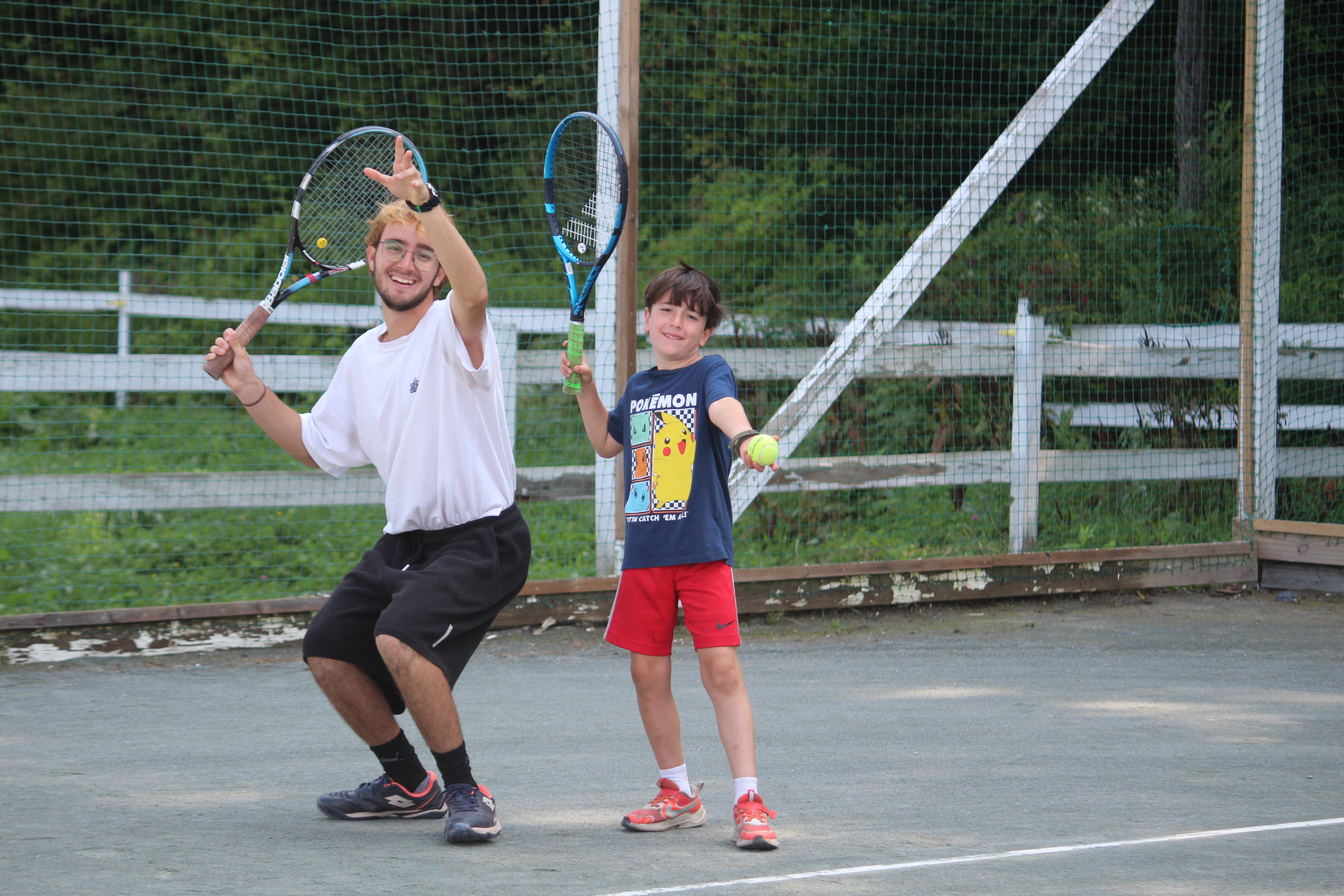 A Windridge tennis counselor with a summer camper